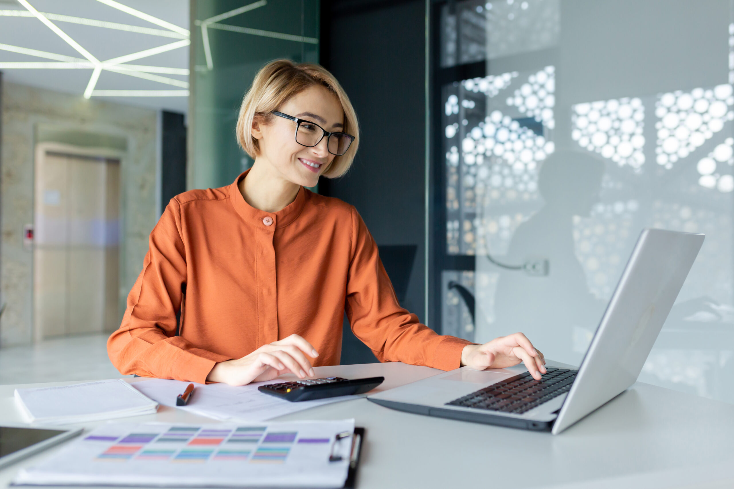 Mandatsträgerin arbeitet konzentriert am Laptop im Büro.